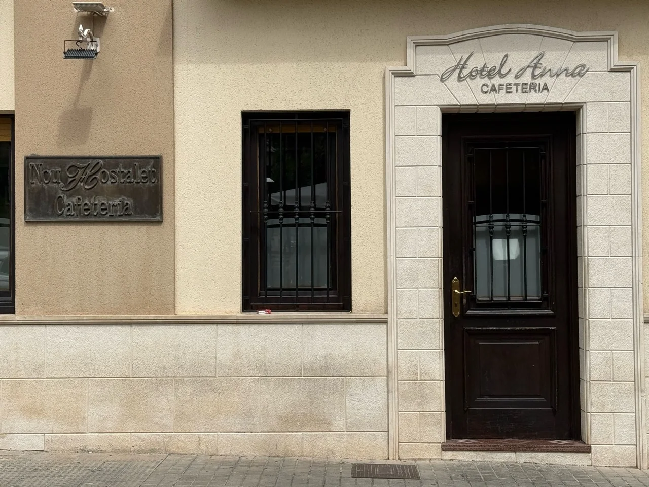 Entrada real de la cafetería Hotel Anna y rótulo Nou Hostalet en Cocentaina